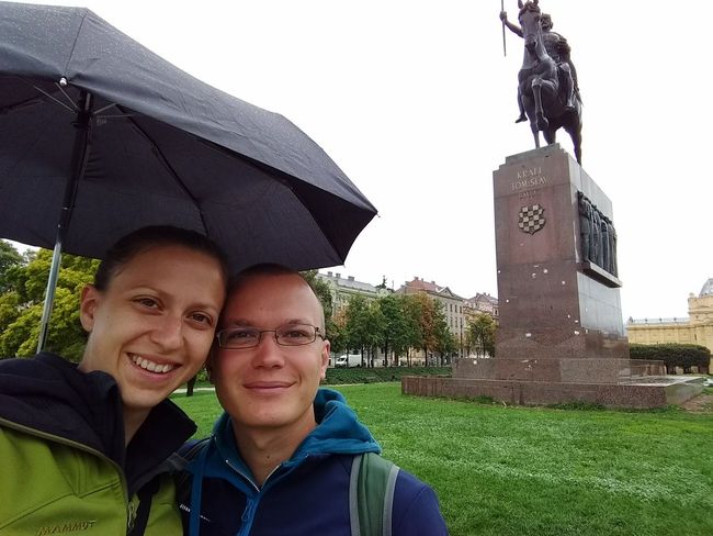 us in front of a statue