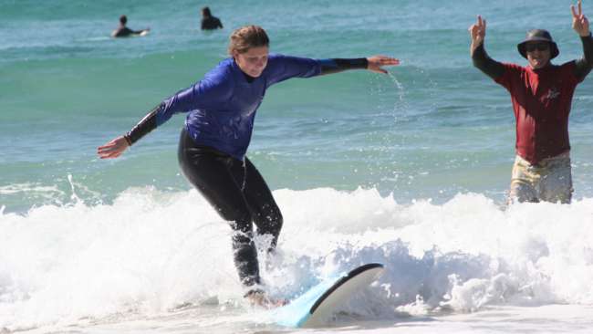 Lisa's first attempts on the surfboard