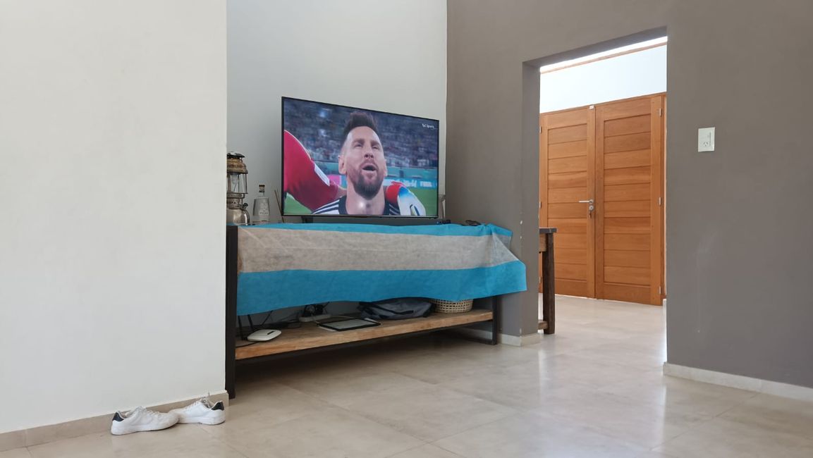 Here's the television, like in every house, decorated with the flag and, ideally, some Panini collectible figures of the national team players. It was also important to always wear the same shirt of the national team, preferably not even washing it from game to game, but I didn't do that. 