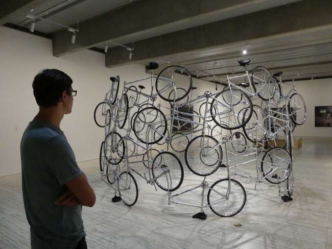 In front of a bicycle artwork