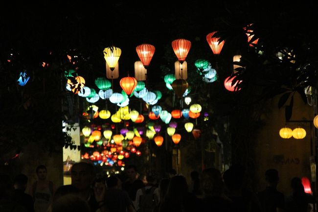 At night: Lanterns hanging above the street and illuminated