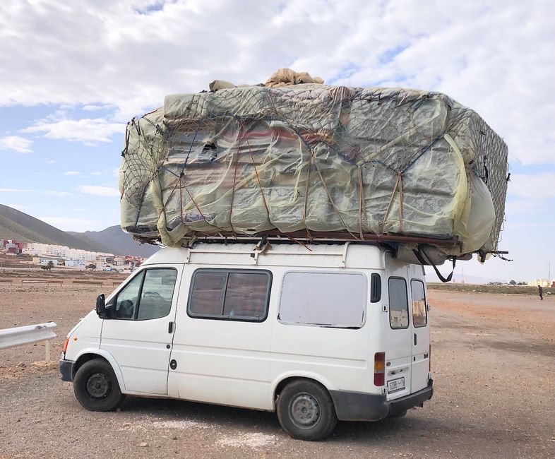 A carpet dealer whose load is larger than the vehicle.