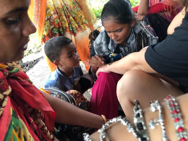 While getting the henna tattoo, with many onlookers