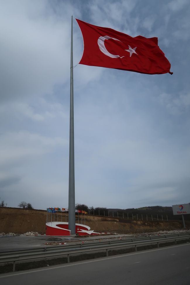 A slightly oversized flagpole on the roadside