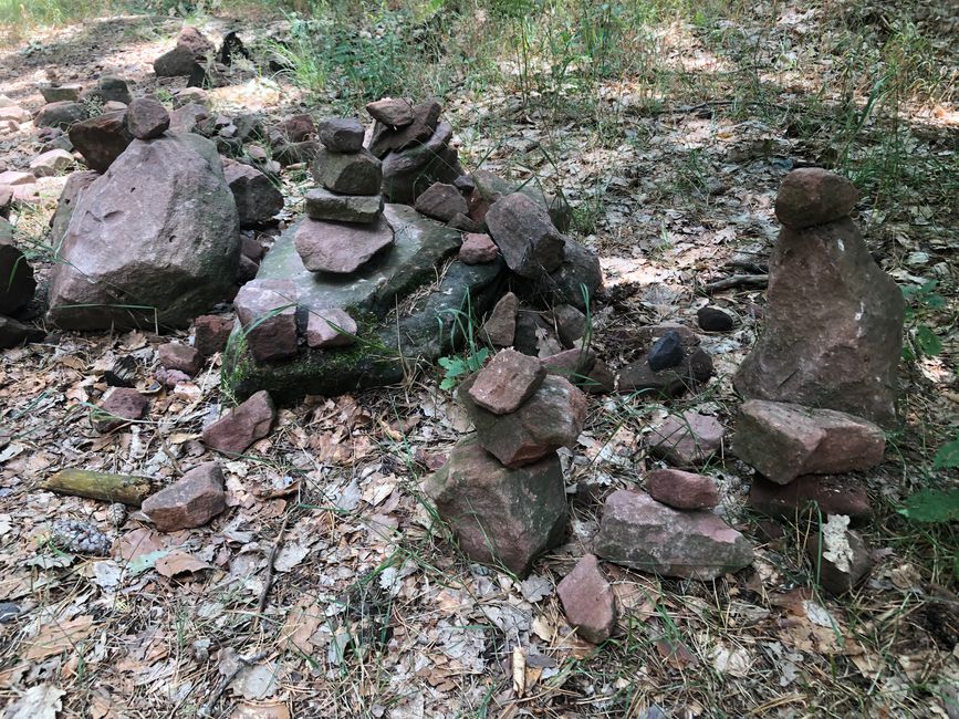Stone piles at the edge of the path