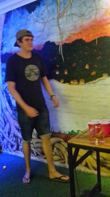 George playing beer pong