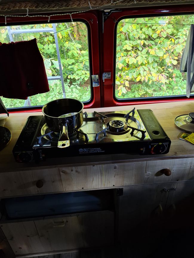 The large drawer and the kitchen counter with the camping stove