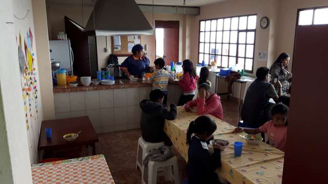 In the dining area - the afternoon children gradually arrive and receive a valuable meal