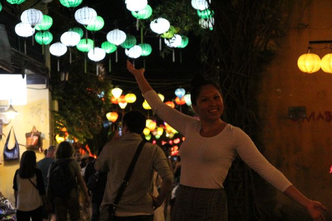 Franzi in front of the brightly shining lanterns at night