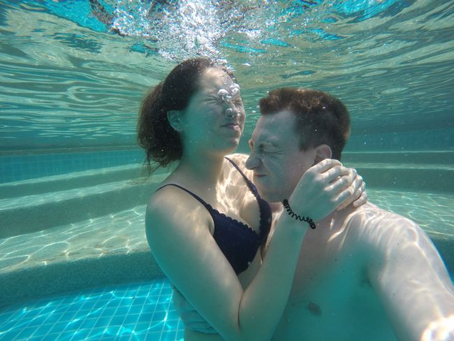 Both of us underwater, arm in arm, squinting