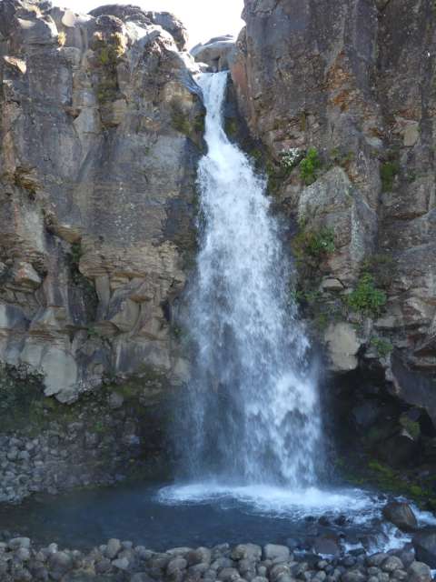 The water cascades down the rock wall