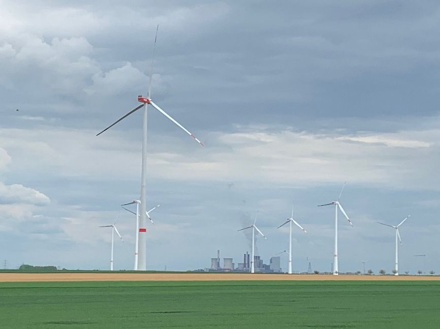 Standing wind turbines and smoking power plants