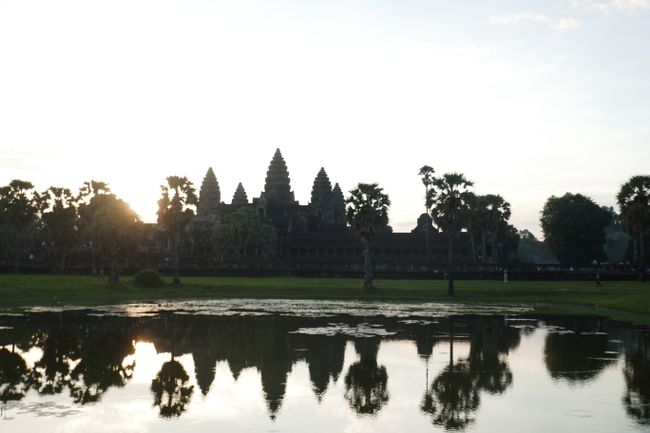The sun rises next to the Angkor Wat temple
