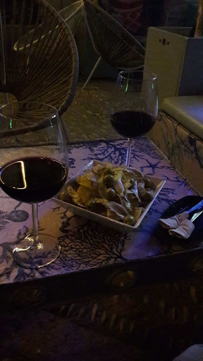 Red wine and chips with olives and sardines