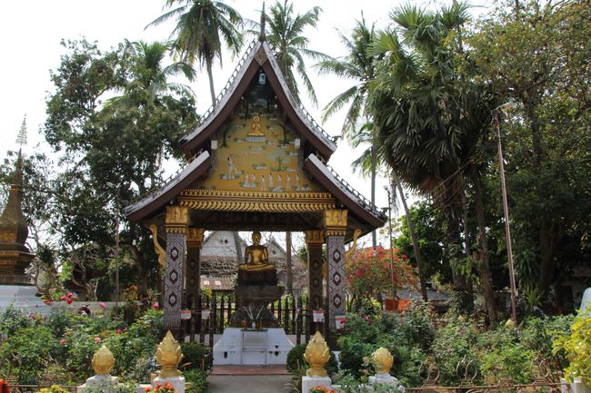On the grounds of Wat Xieng Thong: building with a sitting golden Buddha inside