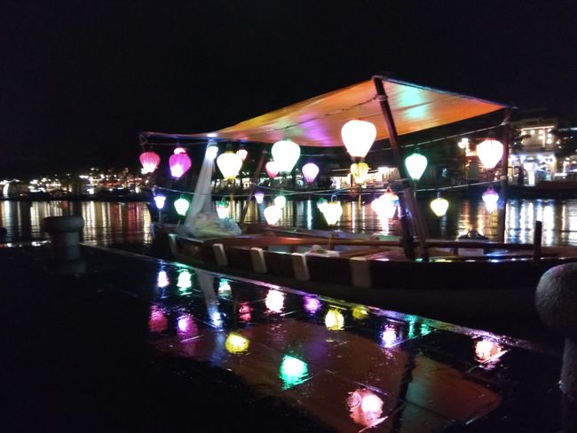 Make the most of the rain: lanterns reflecting on the water on the ground