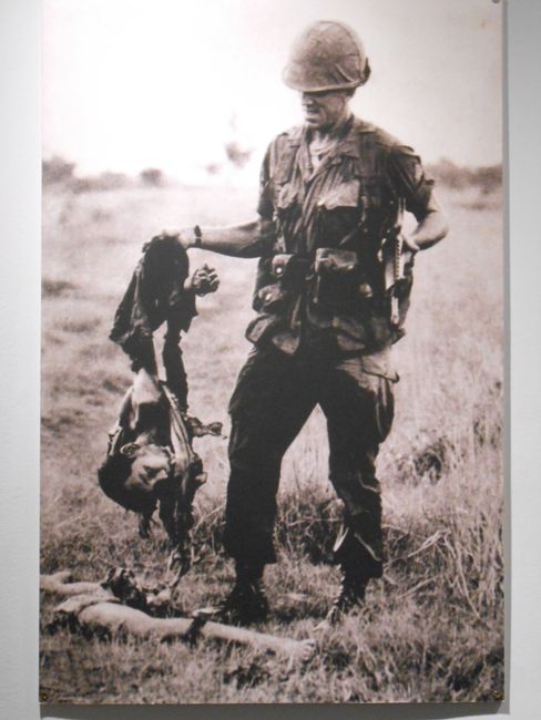 American soldier with the remains of a Viet Cong fighter