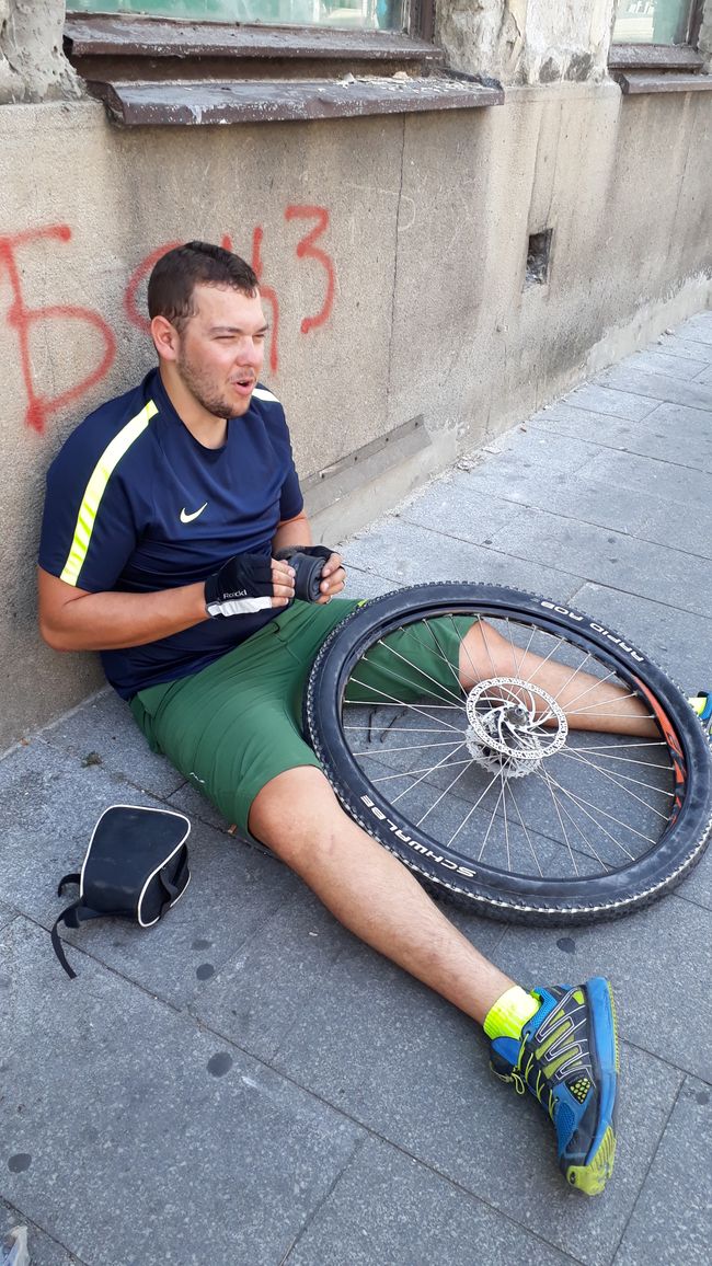 Fixing a bicycle tube 2.0, here on a sidewalk in the middle of Belgrade.