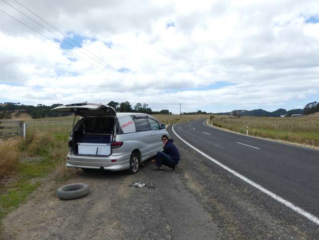 Changing a tire in idyllic landscape