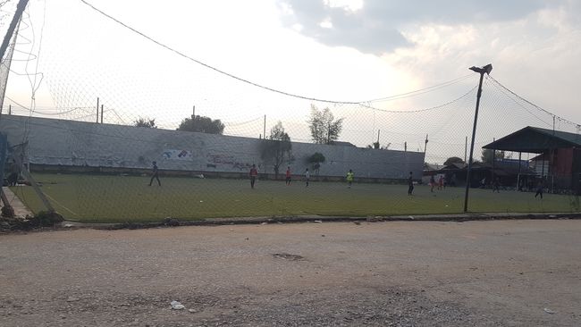 Passing by children playing football. 