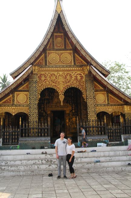 Us in front of Wat Xieng Thong
