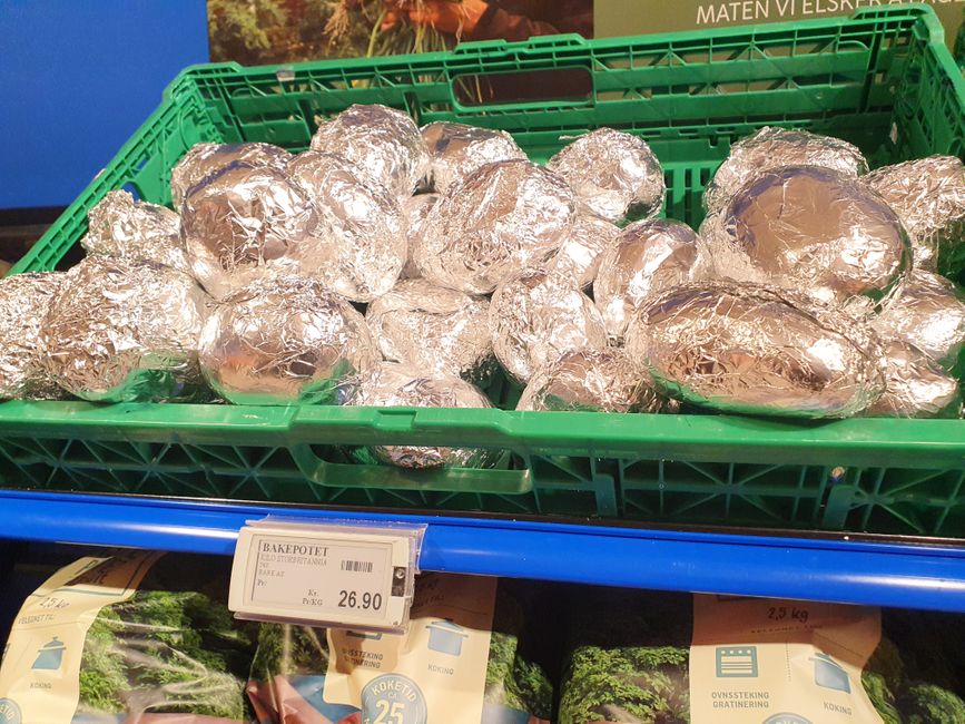 Oven-baked potatoes already wrapped in aluminum foil - a bit oddly wrapped