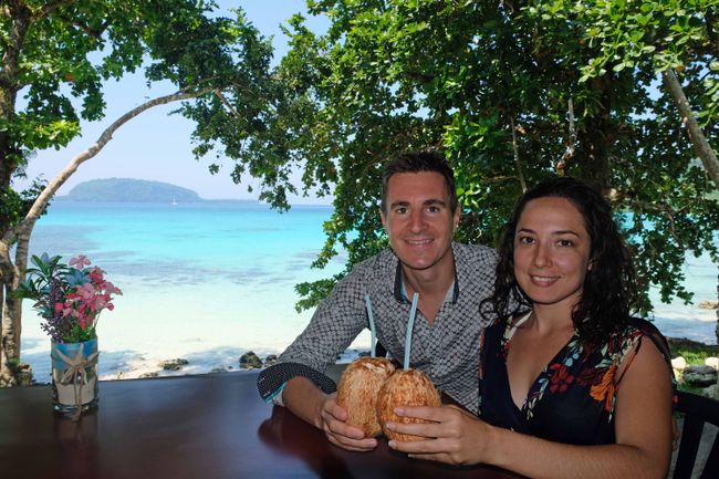 So we get coconuts and flowers to take the perfect South Pacific souvenir photo.