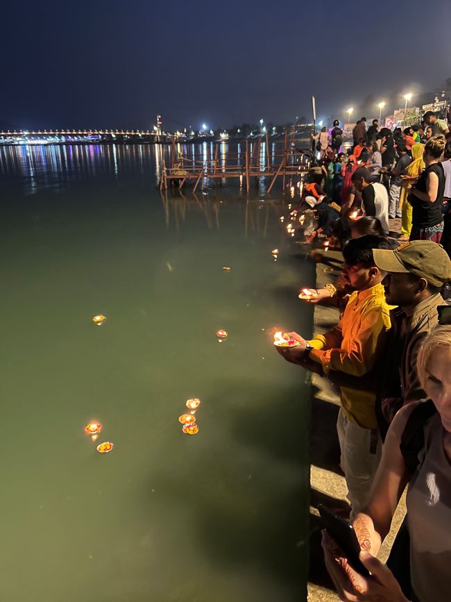 After the Aarti, the flower bowls with candles are sent on their journey. 