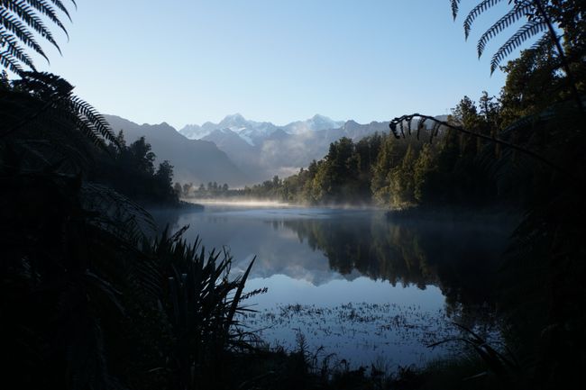 In Lake Matheson, the Mount Tasman is reflected on the left and the Mount Cook on the right