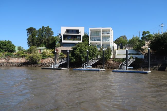 Two of the numerous villas along the Brisbane River with the moorings.