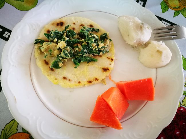 Breakfast: Tortillas with scrambled eggs and mustard leaves, served with sugar cane and papaya