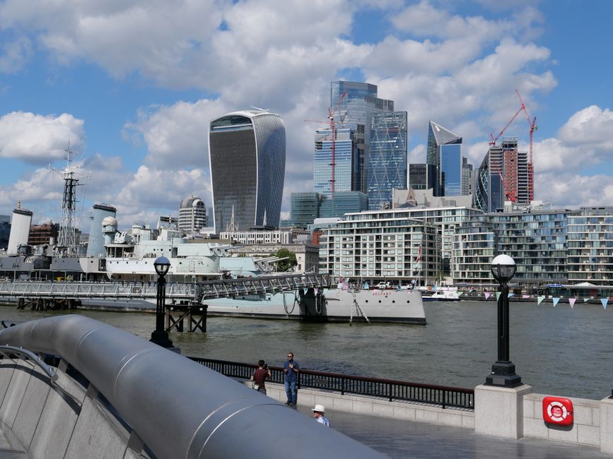 Modern office buildings and in front of them the HMS Belfast