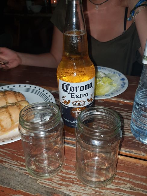 Drinking the cool Frenchies' Corona bottle for dinner in jam jars