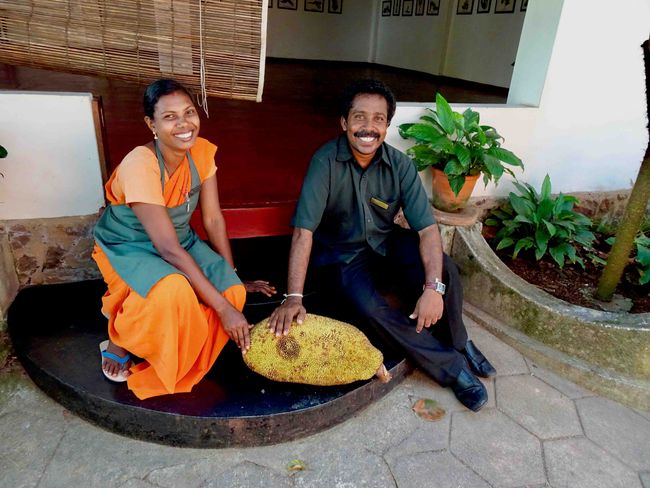 Gardener and assistant with a ripe jackfruit.