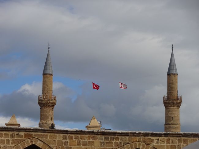 The Turkish and Northern Cypriot flags can be seen on every corner. Here at a mosque in Lefkosa.