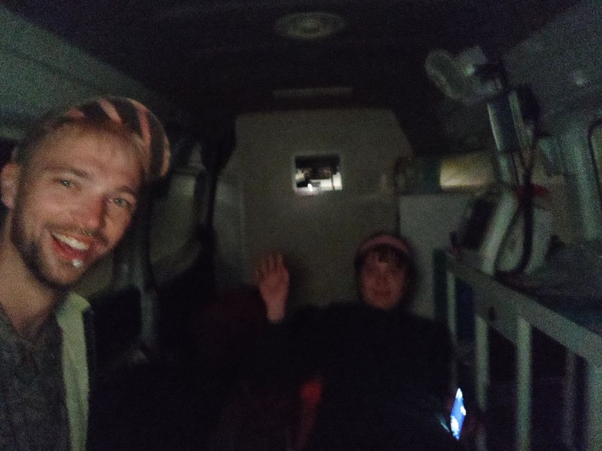 Us hitchhiking in an ambulance