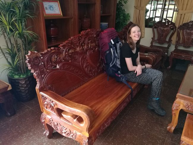 Vanessa waiting on the furniture in the hostel lobby in Kampot.
