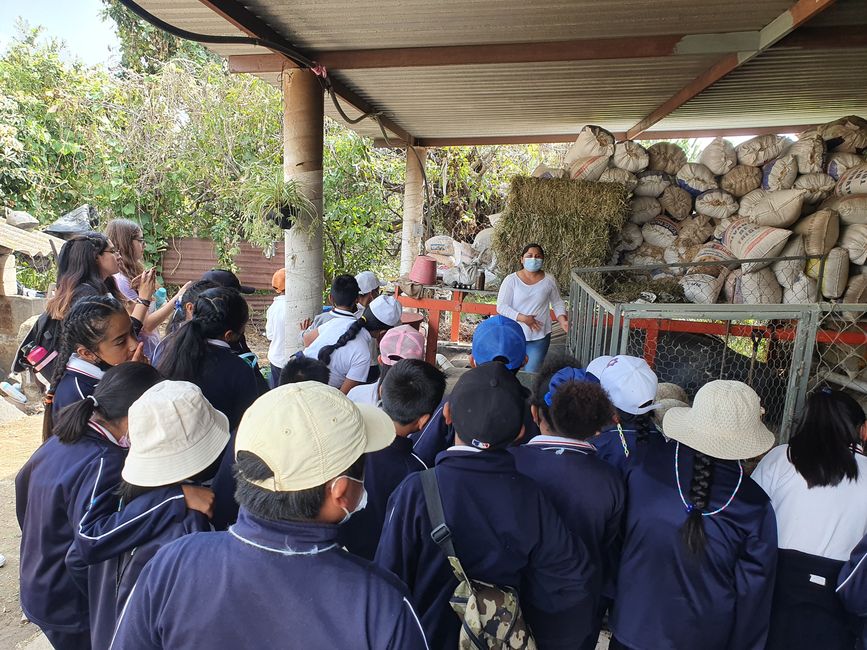 Rosalba explains the bio digester to the children