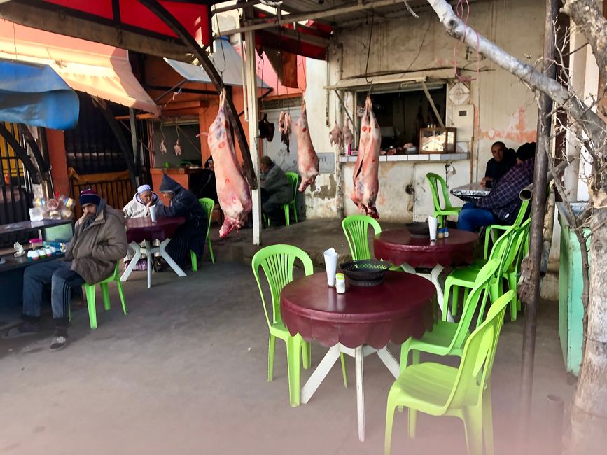 In cafes, fresh meat hangs from the ceiling, even among the chairs.