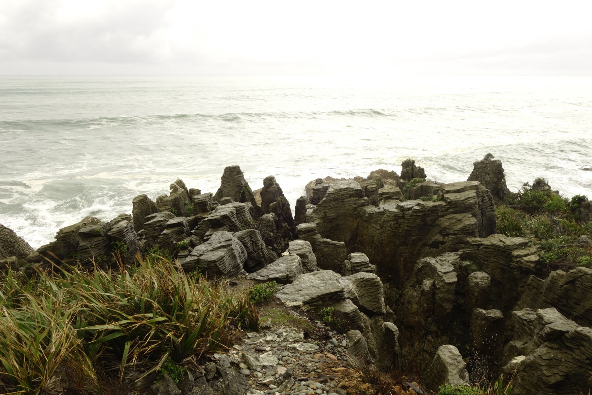 Foreground pancake rocks, behind the sea