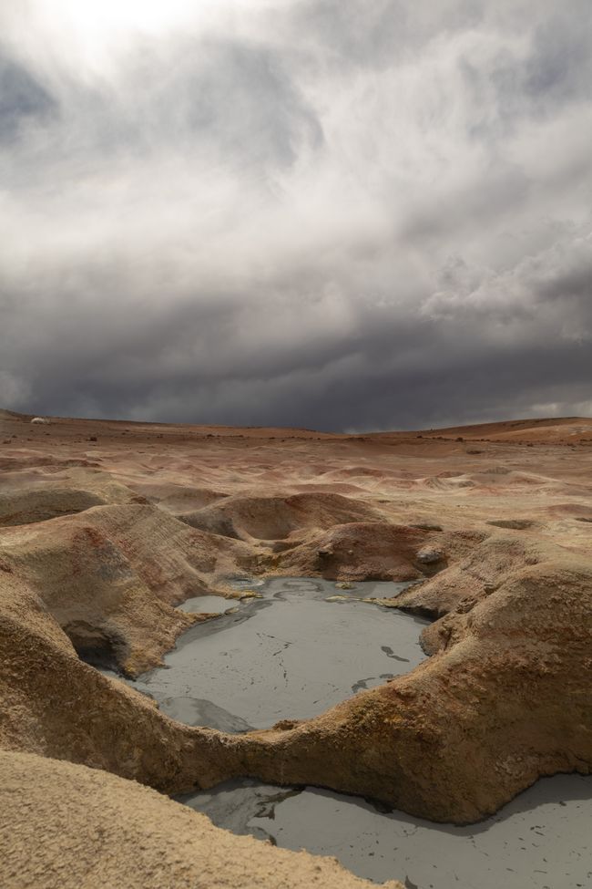 Dark clouds over the sulphurous soup on the Sol de Mañana geyser field