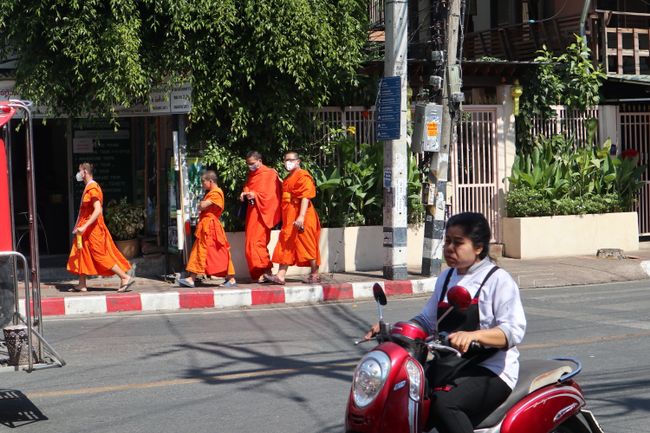 Four monks in the city.