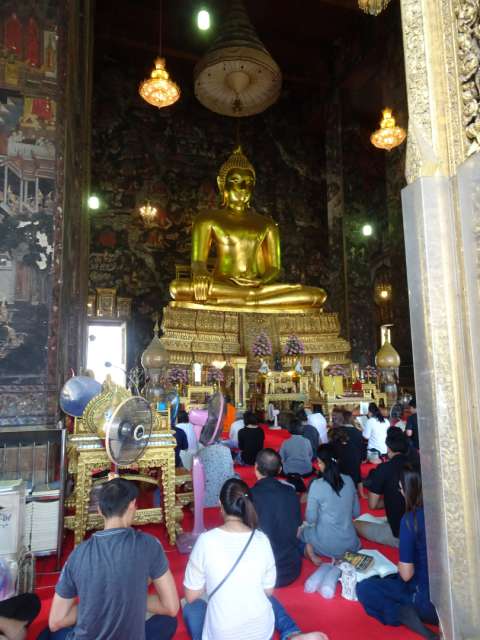 In the Buddhist temple with locals and monks