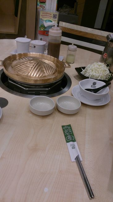 In the middle of the table: The 'pan', bowls, salad & sauces