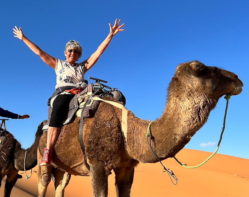 Birgit is having fun on the camel tour through the Sahara.