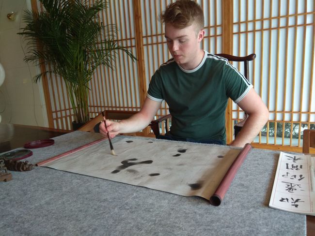 Finlay above Chinese calligraphy in the hotel lobby