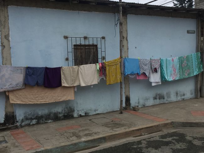 Laundry is hanging outside the houses and right by the sidewalk 🙂