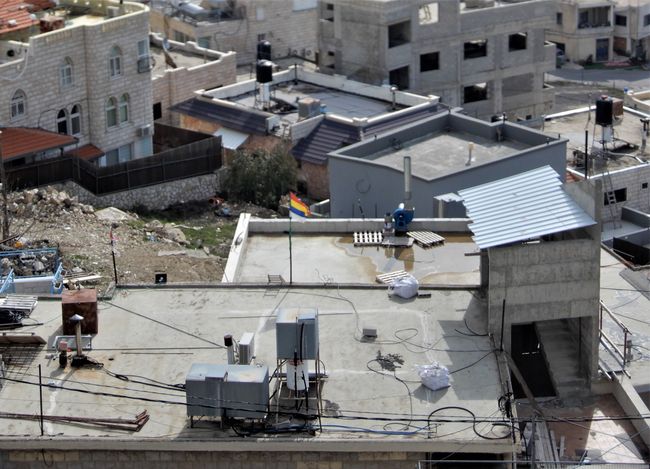 The Druze flag in the morning breeze, which flies on so many roofs in Majdal Shams