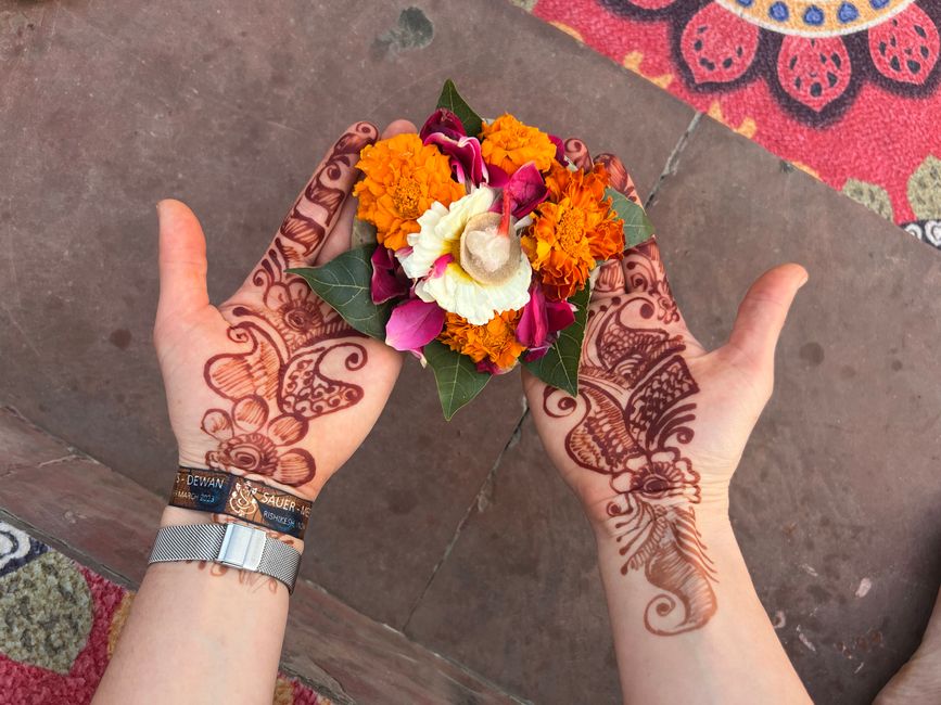 Lotti's flower bowl in her henna-adorned hands. 