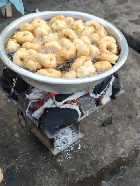 These are like small donuts, they are served with sugar. People cook here usually with fire.